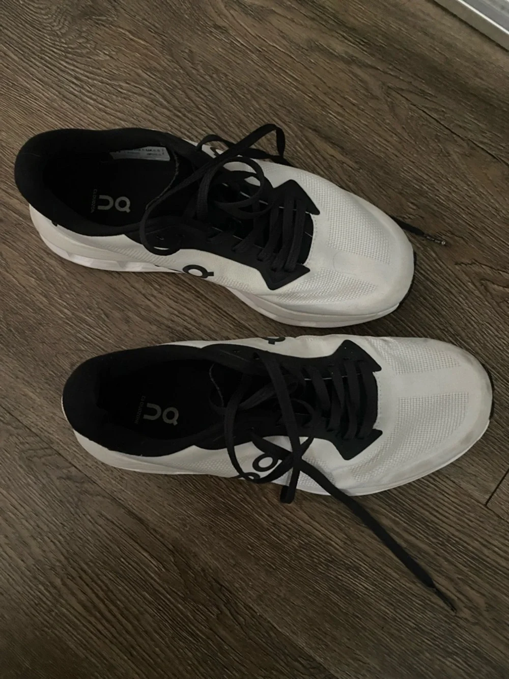 On Running Men’s White and Black Athletic Running Shoes
